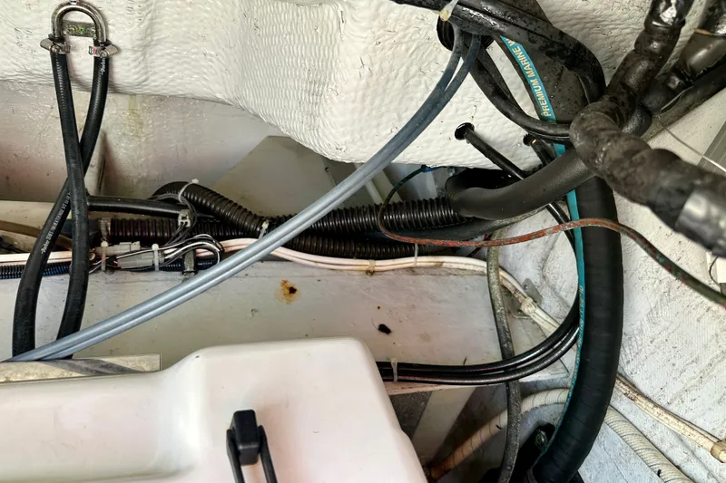 Slide: The Image of 2007 Grady-White Express 330 boat wiring and hoses in engine compartment. - 114