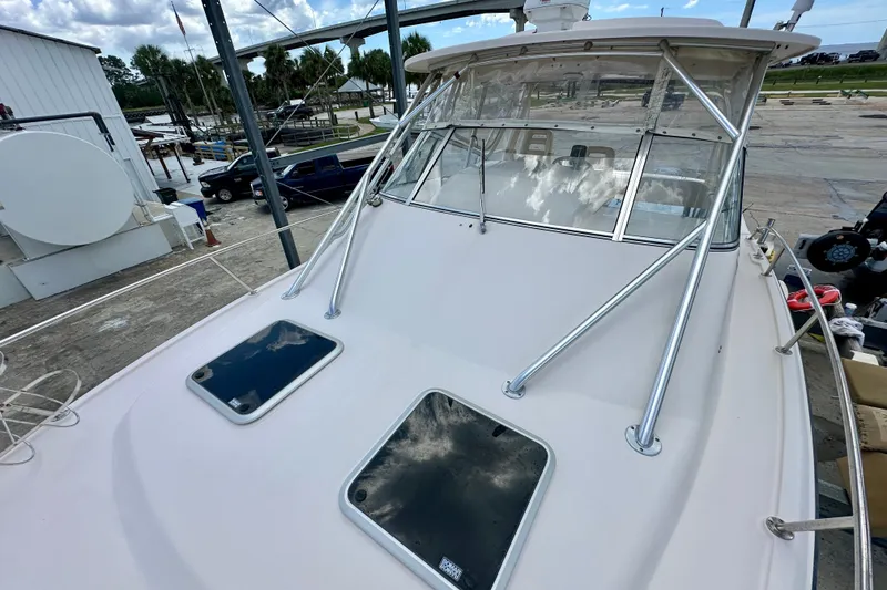 Slide: The Image of 2007 Grady-White Express 330 boat docked, showcasing sleek design and spacious deck. - 33