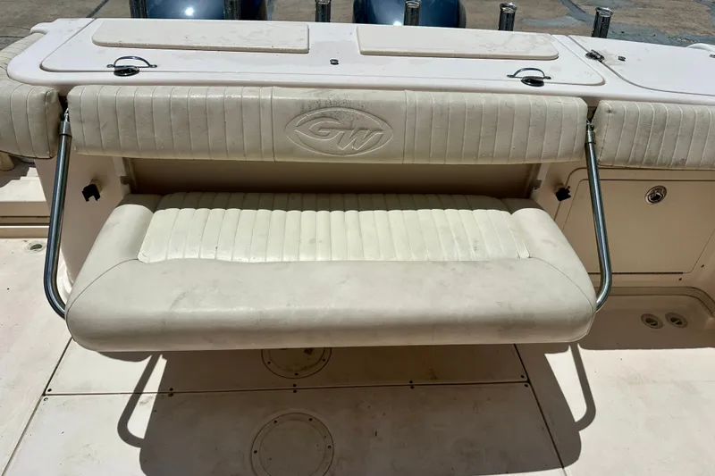 Slide: The Image of 2007 Grady-White Express 330 boat seat with GW logo, featuring stainless steel supports. - 111