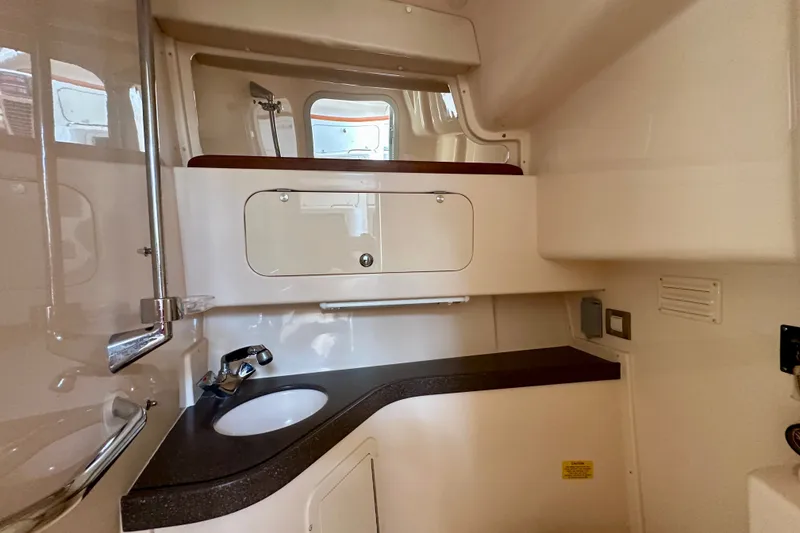 Slide: The Image of 2007 Grady-White Express 330 boat interior with sink and storage cabinet. - 86