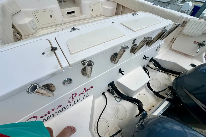 Slide: The Image of 2007 Grady-White Express 330 boat deck with rod holders and Yamaha engines. - 25