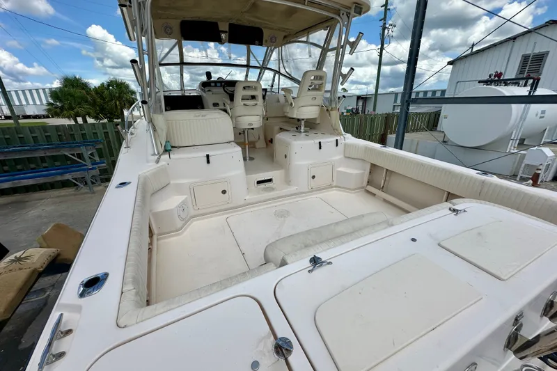 Slide: The Image of 2007 Grady-White Express 330 boat interior with seating and helm, docked outdoors. - 24