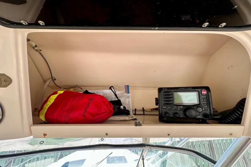 Slide: The Image of 2007 Grady-White Express 330 cabin storage with radio and safety gear. - 64