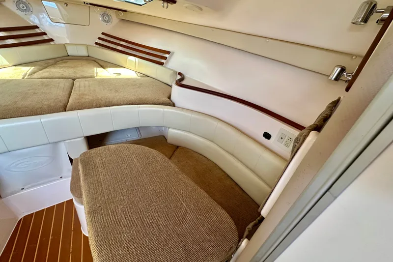 Slide: The Image of Interior cabin of 2007 Grady-White Express 330 boat with cushioned seating and wood accents. - 22