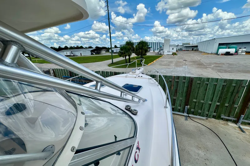Slide: The Image of 2007 Grady-White Express 330 boat docked, showcasing sleek design and clear skies. - 39