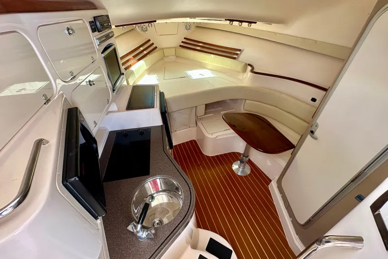 Slide: The Image of Interior of 2007 Grady-White Express 330 boat with kitchenette and seating area. - 75