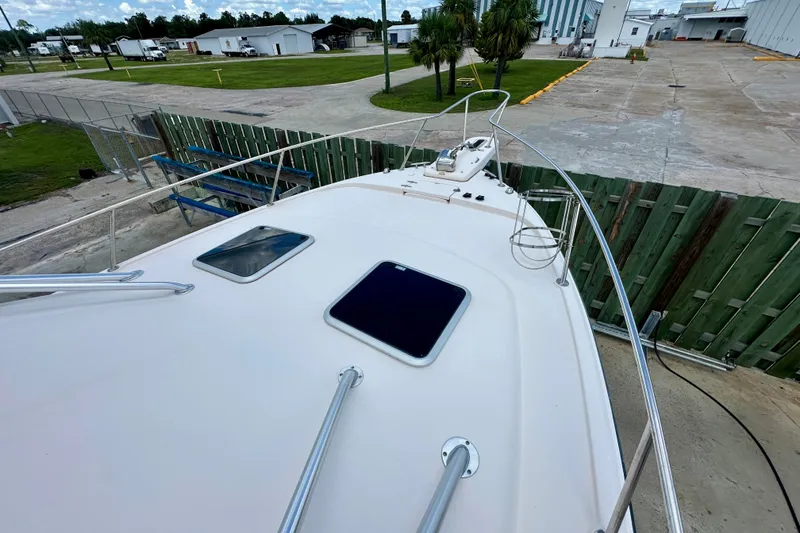 Slide: The Image of 2007 Grady-White Express 330 boat deck with hatches, docked near industrial area. - 38