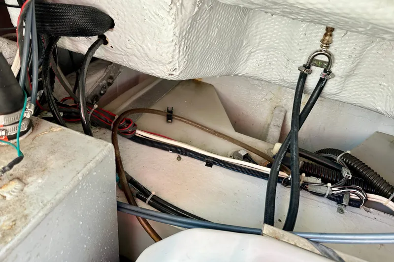 Slide: The Image of Engine compartment of a 2007 Grady-White Express 330 boat, showing wiring and hoses. - 113