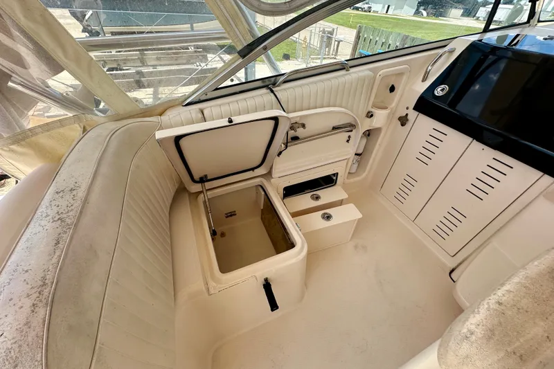 Slide: The Image of 2007 Grady-White Express 330 boat interior with open storage compartment and seating area. - 61