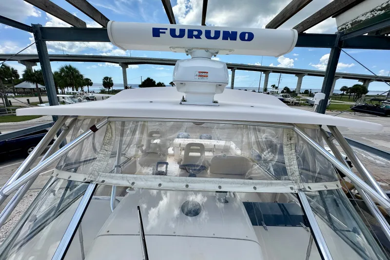 Slide: The Image of 2007 Grady-White Express 330 boat with Furuno radar, docked under a clear sky. - 34