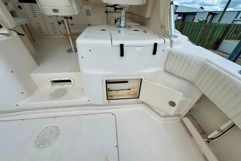 Slide: The Image of 2007 Grady-White Express 330 boat interior with open storage compartment and seating area. - 54