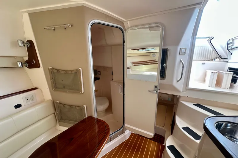 Slide: The Image of Interior of 2007 Grady-White Express 330 boat, featuring cabin and bathroom area. - 84