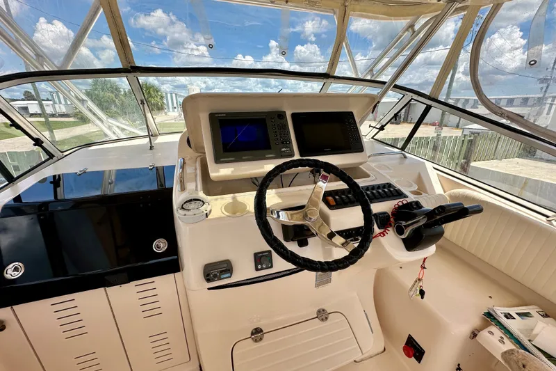 Slide: The Image of Helm of 2007 Grady-White Express 330 boat with steering wheel and navigation equipment. - 72