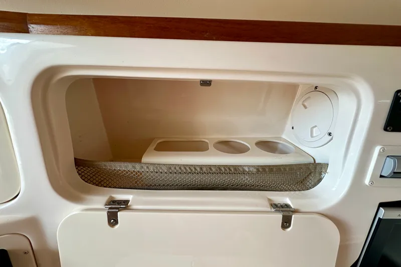 Slide: The Image of Storage compartment on a 2007 Grady-White Express 330 boat with cup holders. - 101