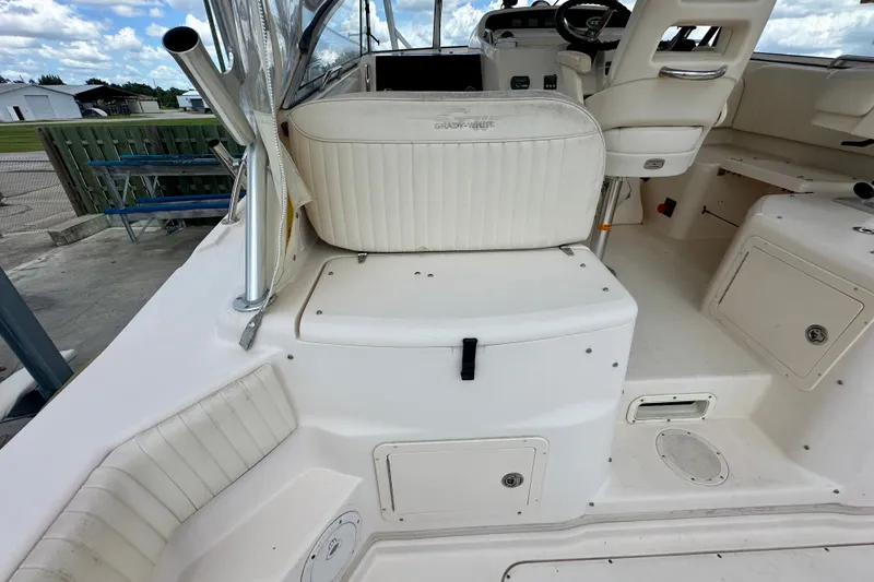 Slide: The Image of 2007 Grady-White Express 330 boat interior with white seating and helm station. - 52