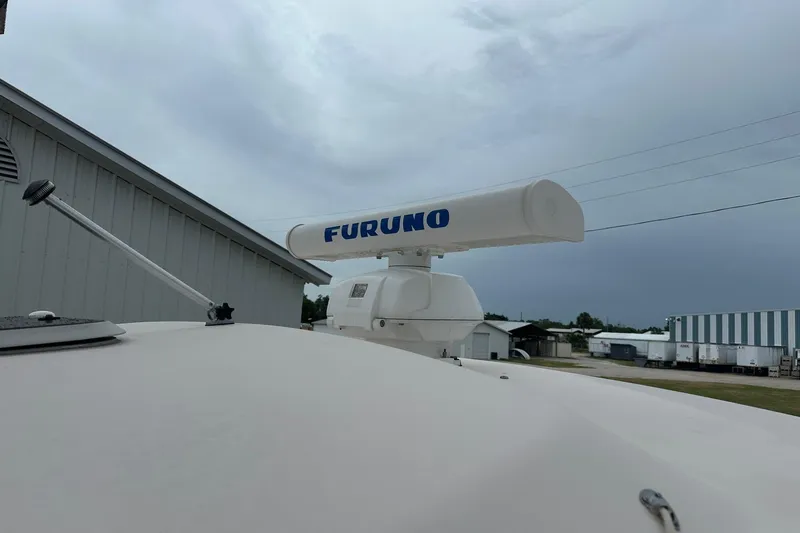 Slide: The Image of Radar equipment on a 2007 Grady-White Express 330 boat under cloudy skies. - 11