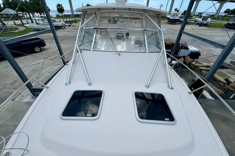 Slide: The Image of 2007 Grady-White Express 330 boat docked, showcasing sleek design and spacious deck. - 36