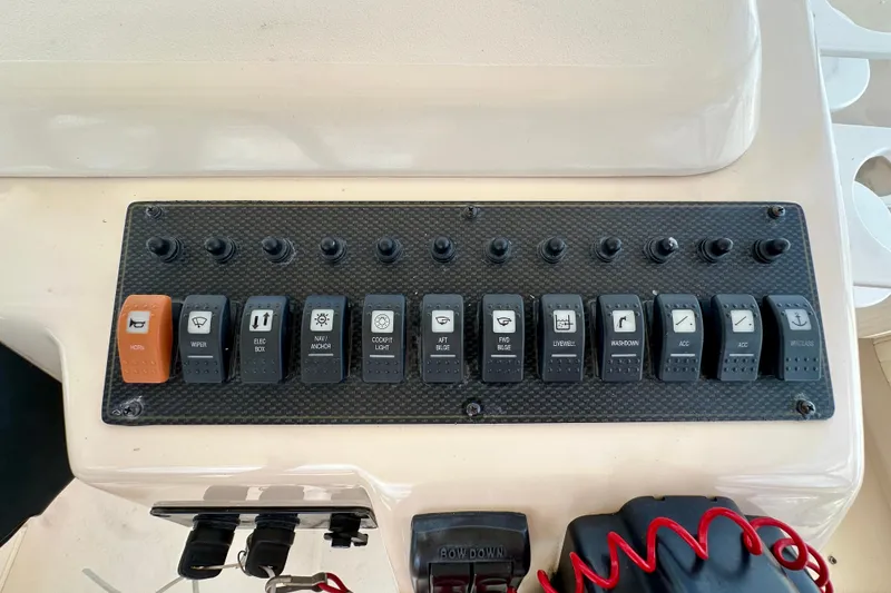 Slide: The Image of Control panel of a 2007 Grady-White Express 330 boat with labeled switches. - 67