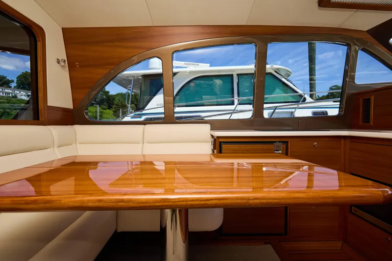 Slide: The Image of Luxurious interior of 2027 Palm Beach 42 yacht with polished wood table and plush seating. - 20
