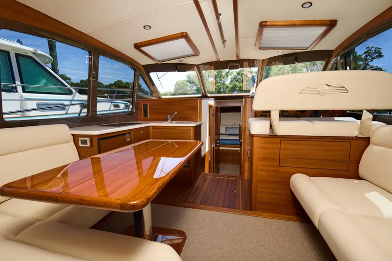 Slide: The Image of Luxurious interior of 2027 Palm Beach 42 yacht with elegant wood finishes and plush seating. - 16