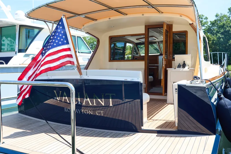 Slide: The Image of 2027 Palm Beach 42 yacht with American flag, docked in a marina. - 7