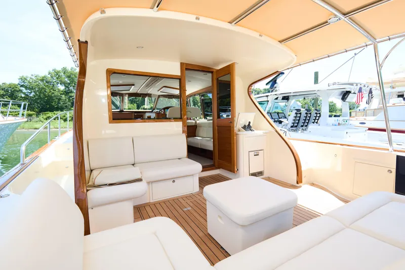 Slide: The Image of Luxurious 2027 Palm Beach 42 yacht interior with elegant seating and wooden accents. - 11
