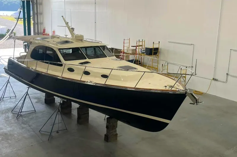 Slide: The Image of 2027 Palm Beach 42 yacht in a workshop, elevated on stands for maintenance. - 6