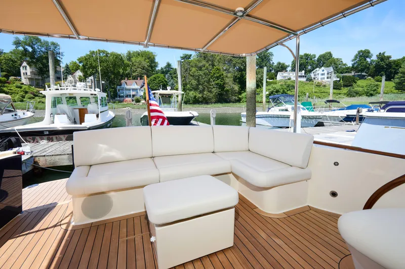 Slide: The Image of Luxurious seating area on 2027 Palm Beach 42 yacht, docked with scenic waterfront views. - 14