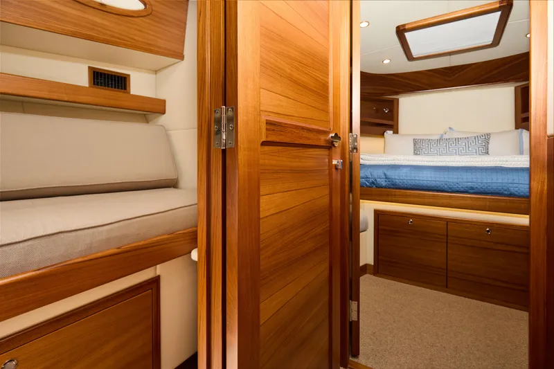 Slide: The Image of Luxurious interior of 2027 Palm Beach 42 yacht with wooden finishes and cozy bedding. - 41