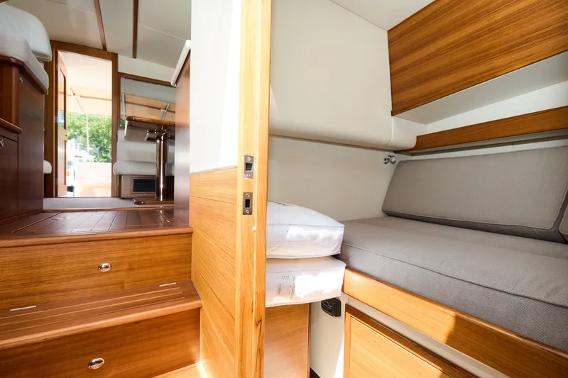 Slide: The Image of Interior of 2027 Palm Beach 42 yacht, featuring wooden finishes and cozy seating area. - 38