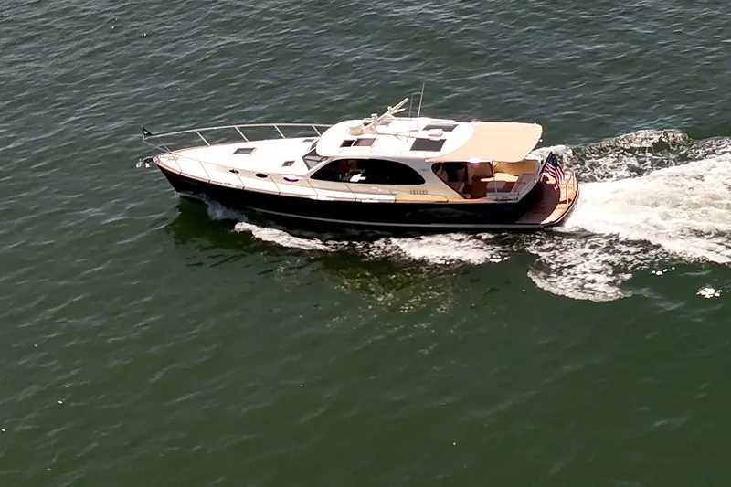 Slide: The Image of 2027 Palm Beach Motor Yachts PB42 cruising on open water. - 1