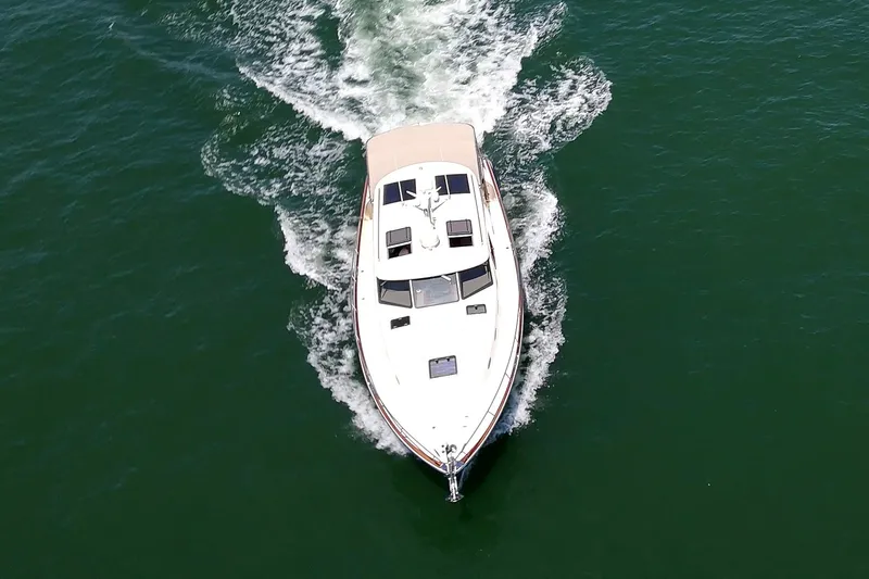 Slide: The Image of 2027 Palm Beach Motor Yachts PB42 cruising on open water, aerial view. - 3