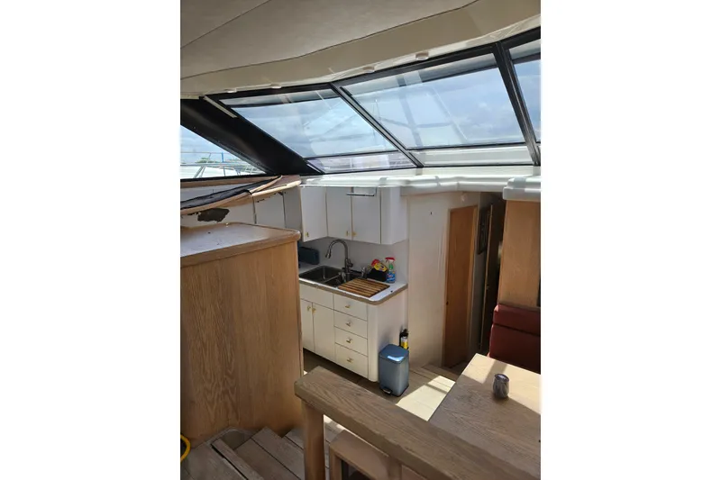 Slide: The Image of Interior of 1993 Silverton 46 Motor Yacht with kitchen and skylight view. - 27
