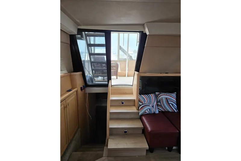 Slide: The Image of Interior of 1993 Silverton 46 Motor Yacht with stairs and colorful cushions. - 45