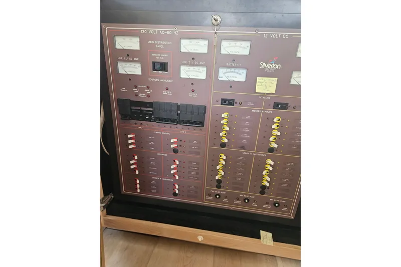 Slide: The Image of Electrical control panel of a 1993 Silverton 46 Motor Yacht, featuring gauges and switches. - 31