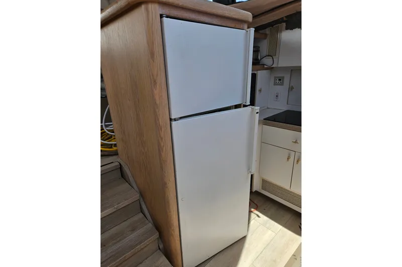 Slide: The Image of Refrigerator in 1993 Silverton 46 Motor Yacht kitchen, featuring wooden cabinetry and modern appliances. - 30