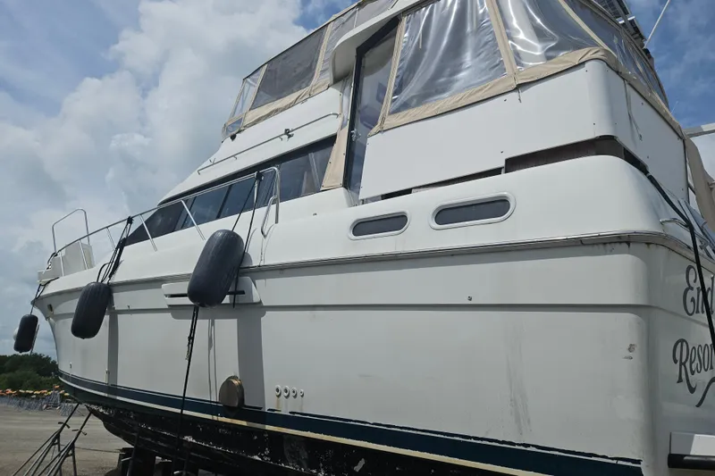 Slide: The Image of 1993 Silverton 46 Motor Yacht on dry dock, showcasing its exterior design and structure. - 59