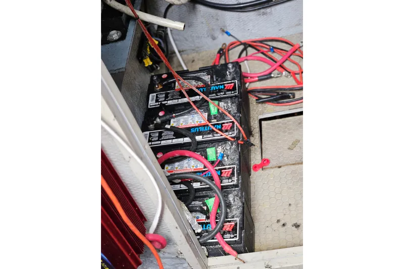 Slide: The Image of Battery compartment of a 1993 Silverton 46 Motor Yacht with connected cables. - 47