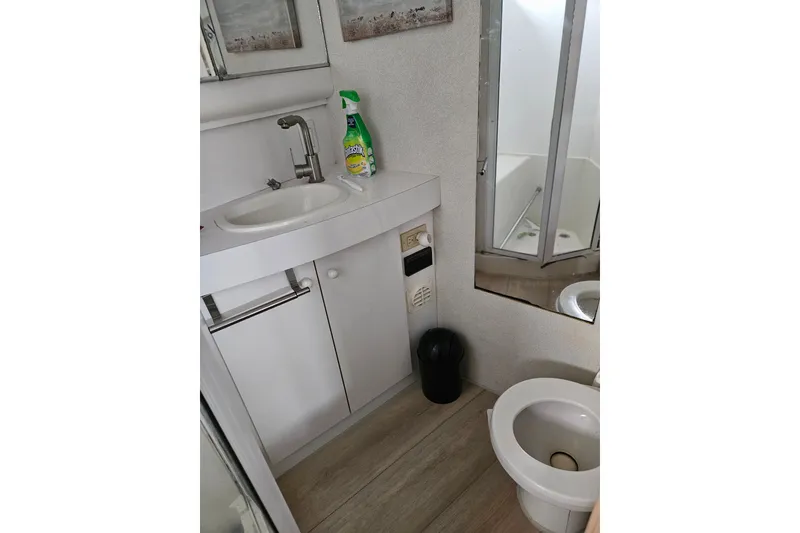 Slide: The Image of Bathroom interior of 1993 Silverton 46 Motor Yacht with sink, toilet, and cleaning supplies. - 39