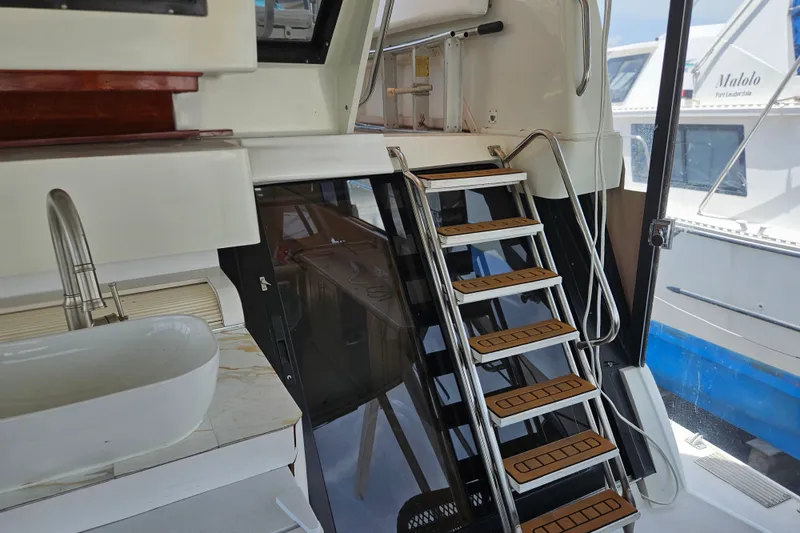 Slide: The Image of Interior view of a 1993 Silverton 46 Motor Yacht with stairs and sink. - 17