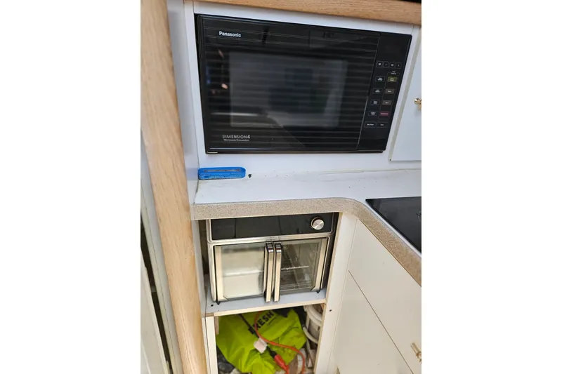 Slide: The Image of Kitchen area of 1993 Silverton 46 Motor Yacht with microwave and oven. - 29