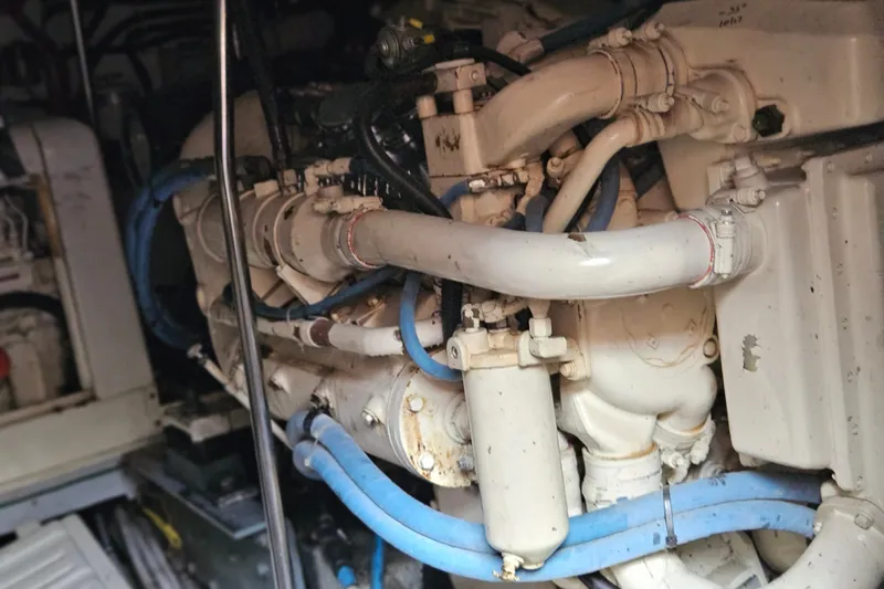 Slide: The Image of Engine room of a 1993 Silverton 46 Motor Yacht with visible pipes and components. - 50