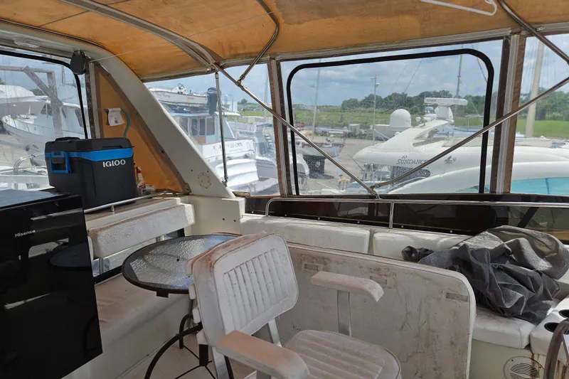 Slide: The Image of Interior view of a 1993 Silverton 46 Motor Yacht with seating and a small table. - 13