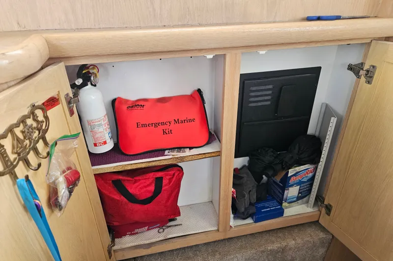 Slide: The Image of Storage cabinet on a 1993 Silverton 46 Motor Yacht with emergency marine kit. - 32