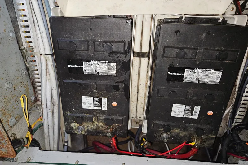 Slide: The Image of Battery compartment of a 1993 Silverton 46 Motor Yacht with wiring and labels visible. - 55
