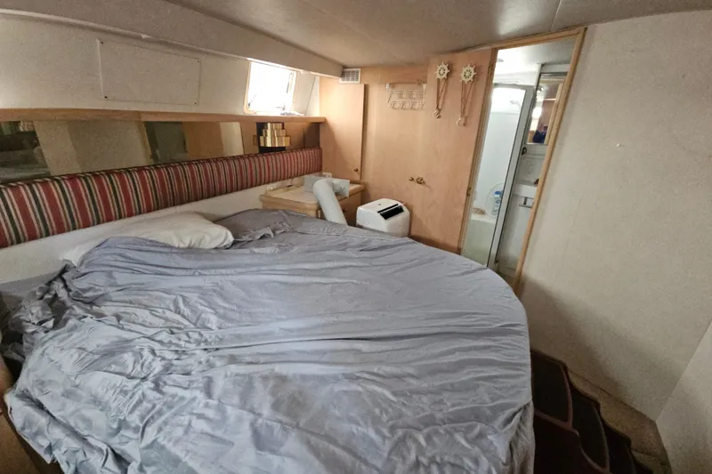 Slide: The Image of Interior cabin of a 1993 Silverton 46 Motor Yacht with bed and bathroom. - 37