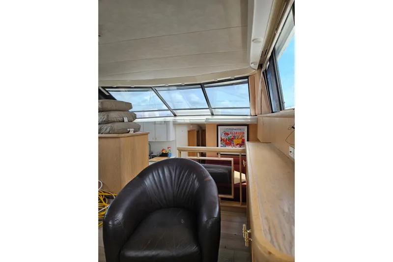 Slide: The Image of Interior of 1993 Silverton 46 Motor Yacht with leather chair and large windows. - 44