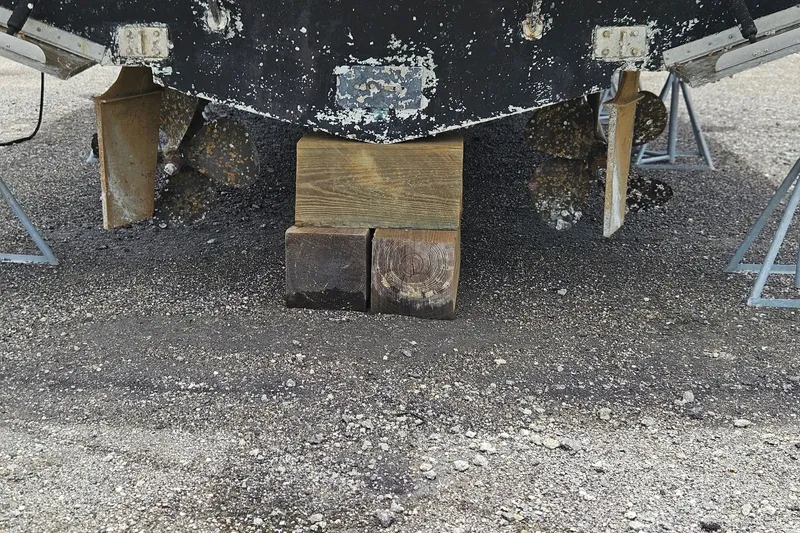 Slide: The Image of 1993 Silverton 46 Motor Yacht on blocks, showing propellers and rudders. - 60