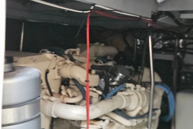 Slide: The Image of Engine room of a 1993 Silverton 46 Motor Yacht, showcasing mechanical components and wiring. - 51