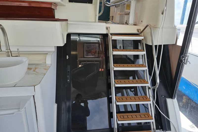 Slide: The Image of Interior view of 1993 Silverton 46 Motor Yacht with stairs and sink. - 19